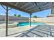 The backyard pool and spa are perfect for entertaining and enjoying sunny days under a charming pergola at 744 Willow Ave, Henderson, NV 89002