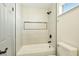 Bright bathroom with white tiled shower, black fixtures, and a built in shelf at 744 Willow Ave, Henderson, NV 89002