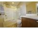 Bathroom with a bathtub, shower, sliding glass door, and a wood vanity at 7653 Fabled Filigree St, Las Vegas, NV 89149