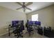 Bright, airy room with a ceiling fan and ample space for a home office setup at 7653 Fabled Filigree St, Las Vegas, NV 89149