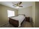 Cozy bedroom featuring neutral walls, carpeted floors, and a ceiling fan with lighting at 7653 Fabled Filigree St, Las Vegas, NV 89149