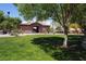 Grassy area with shade trees and community center building in the background at 7653 Fabled Filigree St, Las Vegas, NV 89149