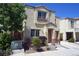 Inviting two-story home featuring a cute, fenced front porch and attached single-car garage at 7653 Fabled Filigree St, Las Vegas, NV 89149