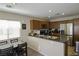 Modern kitchen with stainless steel appliances, ample cabinetry, and a breakfast bar at 7653 Fabled Filigree St, Las Vegas, NV 89149