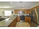 Well-equipped kitchen with stainless steel appliances, wood cabinets, and efficient layout at 7653 Fabled Filigree St, Las Vegas, NV 89149