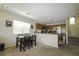 Open concept kitchen area with stainless steel appliances and a cozy dining area at 7653 Fabled Filigree St, Las Vegas, NV 89149