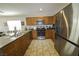 Well-equipped kitchen featuring stainless steel appliances and stylish tile flooring at 7653 Fabled Filigree St, Las Vegas, NV 89149