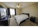 Comfortable bedroom with a ceiling fan, dark drapes, and dresser at 7653 Fabled Filigree St, Las Vegas, NV 89149