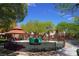 Community playground with gazebo, swings, and bright green play area at 7653 Fabled Filigree St, Las Vegas, NV 89149