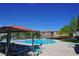 Sparkling community pool surrounded by lounge chairs and lush greenery, perfect for relaxing at 7653 Fabled Filigree St, Las Vegas, NV 89149