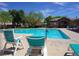 Inviting community pool with clear blue water and lounge chairs for residents to enjoy at 7653 Fabled Filigree St, Las Vegas, NV 89149