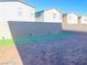 A backyard offers a patterned brick patio with small grass patches along the wall at 7892 W Shelbourne Ave, Las Vegas, NV 89113