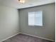 A cozy bedroom features neutral carpet, gray walls, and a window with horizontal blinds at 7892 W Shelbourne Ave, Las Vegas, NV 89113