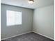 A well-lit bedroom offers plush carpet, gray walls, and a window with covering at 7892 W Shelbourne Ave, Las Vegas, NV 89113