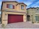 Two-story home featuring brick driveway and a two-car garage with eye-catching red door and window shutters at 7892 W Shelbourne Ave, Las Vegas, NV 89113