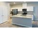 Modern kitchen with white cabinets, granite countertops, stainless steel appliances, and a central island at 7892 W Shelbourne Ave, Las Vegas, NV 89113