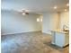 Spacious living room and kitchen area featuring a granite countertop island and neutral paint at 7892 W Shelbourne Ave, Las Vegas, NV 89113