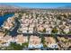 A serene neighborhood with luxurious houses, palm trees, and scenic mountain views from above at 8125 Sunset Cove Dr, Las Vegas, NV 89128