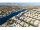 Overhead perspective of a waterfront neighborhood exhibiting well-manicured yards, houses, and waterways at 8125 Sunset Cove Dr, Las Vegas, NV 89128