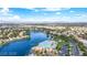 Aerial view showcasing a resort-style pool and community lake surrounded by homes and palm trees at 8125 Sunset Cove Dr, Las Vegas, NV 89128