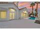 Home exterior features a white stucco exterior, a red tile roof, and a swimming pool at 8125 Sunset Cove Dr, Las Vegas, NV 89128
