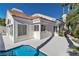 Exterior view of a home and pool, showing stucco walls and a tile roof at 8125 Sunset Cove Dr, Las Vegas, NV 89128
