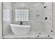Modern bathroom featuring a soaking tub, glass shower, and sleek fixtures at 8125 Sunset Cove Dr, Las Vegas, NV 89128