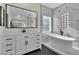 Modern bathroom featuring a standalone tub, shower, and dual sink vanity at 8125 Sunset Cove Dr, Las Vegas, NV 89128