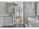 Modern bathroom features a sleek vanity, soaking tub with marble surround and updated fixtures at 8125 Sunset Cove Dr, Las Vegas, NV 89128