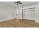 Comfortable bedroom with wood floors, ceiling fan, walk-in closet with built-in shelves at 8125 Sunset Cove Dr, Las Vegas, NV 89128