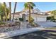 Home exterior with desert landscaping, tile roof, and two car garage at 8125 Sunset Cove Dr, Las Vegas, NV 89128
