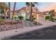 Elegant two-story home featuring desert landscaping, a three-car garage, and a welcoming, lighted entryway at 8125 Sunset Cove Dr, Las Vegas, NV 89128