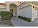 View of the front entrance, driveway, and garage of a modern home with manicured landscaping at 8125 Sunset Cove Dr, Las Vegas, NV 89128