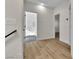 Hallway with wood floors leads to an updated bathroom with a tiled shower enclosure at 8125 Sunset Cove Dr, Las Vegas, NV 89128