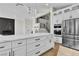 Kitchen featuring white cabinetry, stainless steel appliances, and a large island with white countertop at 8125 Sunset Cove Dr, Las Vegas, NV 89128