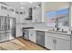 Updated kitchen with stainless steel appliances, white cabinets, and bright natural light at 8125 Sunset Cove Dr, Las Vegas, NV 89128
