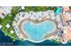 Aerial view of a lagoon pool with blue umbrellas, lounge chairs, and sandy beach at 8125 Sunset Cove Dr, Las Vegas, NV 89128