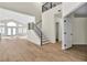 Spacious main living area with staircase, natural-tone wood floors and ample natural light at 8125 Sunset Cove Dr, Las Vegas, NV 89128