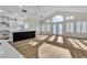 Bright living room featuring white cabinetry, a large island, lots of natural light, and wood flooring at 8125 Sunset Cove Dr, Las Vegas, NV 89128