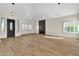 Spacious, light-filled living room with modern light fixtures and wood flooring at 8125 Sunset Cove Dr, Las Vegas, NV 89128