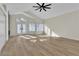 Bright living room with wood floors, vaulted ceiling, and a modern ceiling fan at 8125 Sunset Cove Dr, Las Vegas, NV 89128