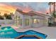 Back of home featuring patio, pool, and large windows offering an abundance of natural light at 8125 Sunset Cove Dr, Las Vegas, NV 89128