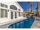 Backyard swimming pool view highlighting tile, and manicured landscaping in the distance at 8125 Sunset Cove Dr, Las Vegas, NV 89128