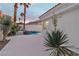Landscaped yard featuring a pool and spa, with native plants set against a white privacy wall at 8125 Sunset Cove Dr, Las Vegas, NV 89128