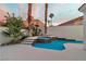 Backyard pool and spa area, complemented by swaying palm trees and sleek white concrete at 8125 Sunset Cove Dr, Las Vegas, NV 89128