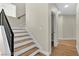 Modern staircase with wood treads and a sleek, black metal railing at 8125 Sunset Cove Dr, Las Vegas, NV 89128