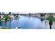 Scenic water view overlooking a community lake with palm trees and waterfront homes at 8125 Sunset Cove Dr, Las Vegas, NV 89128