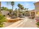 Spectacular backyard oasis with a pool, spa, lush landscaping, a cozy outdoor fireplace and lounge area at 8801 Rozetta Ct, Las Vegas, NV 89134