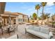 Beautiful backyard pool area featuring palm trees, a waterfall spa, patio furniture, and a covered lounge area at 8801 Rozetta Ct, Las Vegas, NV 89134