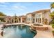 Stunning backyard pool and spa with beautiful patio and covered outdoor living areas surrounded by greenery at 8801 Rozetta Ct, Las Vegas, NV 89134